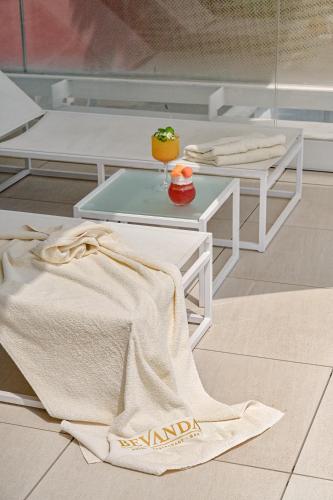 a towel on the floor next to a coffee table at Bevanda Hotel & Restaurant - Unique Adriatic in Opatija