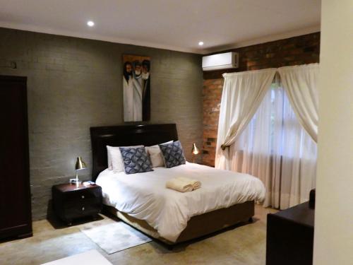 Ένα ή περισσότερα κρεβάτια σε δωμάτιο στο Maretlwane Guesthouse