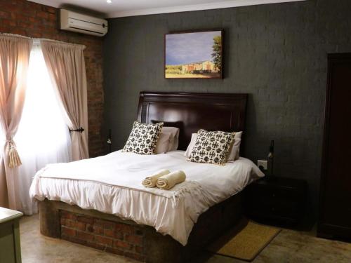 Ένα ή περισσότερα κρεβάτια σε δωμάτιο στο Maretlwane Guesthouse