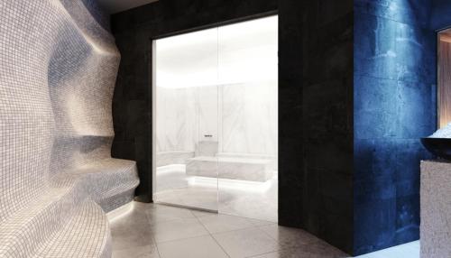 a bathroom with a glass shower door with a toilet at Apartman Kopaonik Woodside 106 in Kopaonik