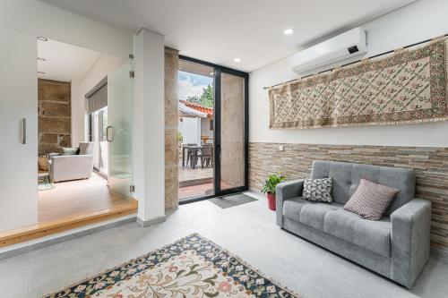 a living room with a couch and a brick wall at Sevenfarm in Mangualde