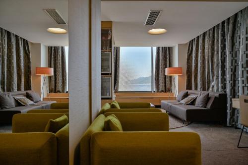 a living room with couches and chairs and a window at Bevanda Hotel & Restaurant - Unique Adriatic in Opatija