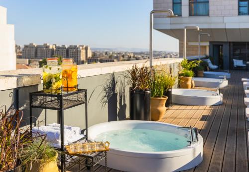 a bath tub sitting on top of a balcony at Brown Machne Yehuda in Jerusalem