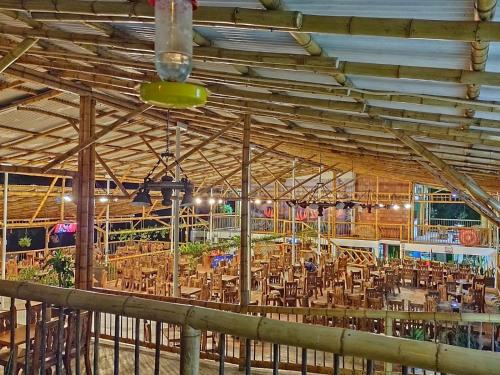 a large wooden building with tables and chairs at Casa Flórez Hotel Campestre in Ibagué