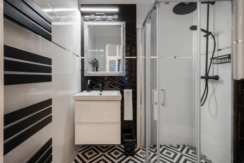 a bathroom with a sink and a shower at Premium Art Deco Apartment at Broadway // 4BDR & 3BR in Budapest
