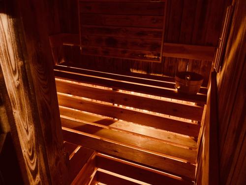 an empty wooden sauna with a bucket on the stairs at Chalupa Zdíkov na Šumavě in Zdíkov
