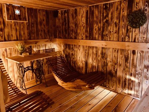 a wooden room with a bench and a table at Chalupa Zdíkov na Šumavě in Zdíkov