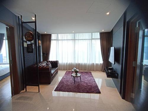 a living room with a couch and a table at The Luxury Penthouse Twin Tower view in Kuala Lumpur
