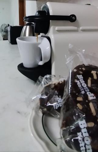 a piece of chocolate cake on a counter with a cup of coffee at In the Heart of Bugibba in St. Paul's Bay