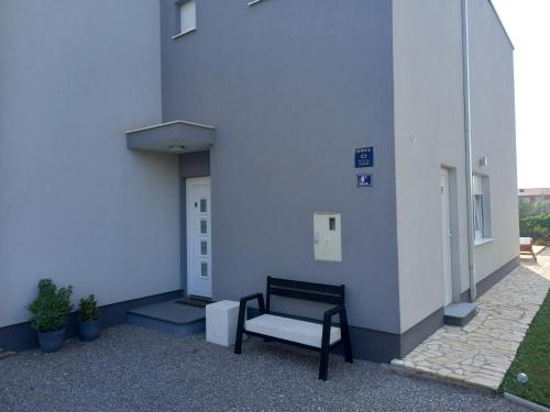 a bench sitting on the side of a building at Villa Fidelissima in Kaštela