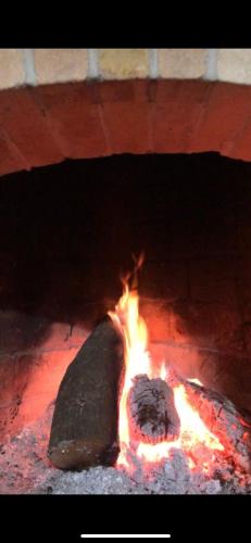 a fire in a brick oven with flames in it at Sunnyside Villa in Durrës