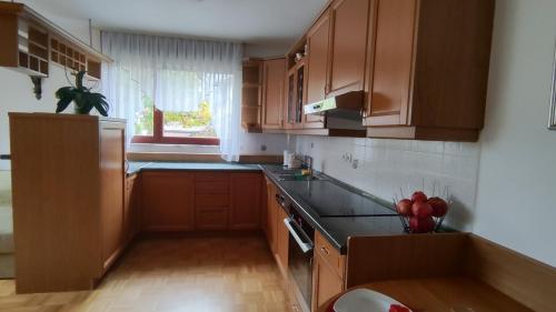a kitchen with wooden cabinets and a black counter top at Apartma Alda in Preserje