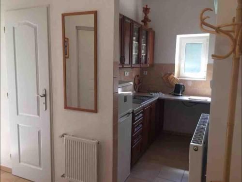 a kitchen with a white refrigerator and a window at Apartmán Oáza DC in Děčín
