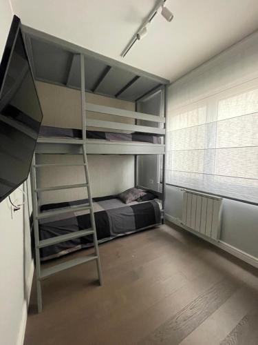 a bedroom with bunk beds with a ladder in it at Naomi in Voždivac