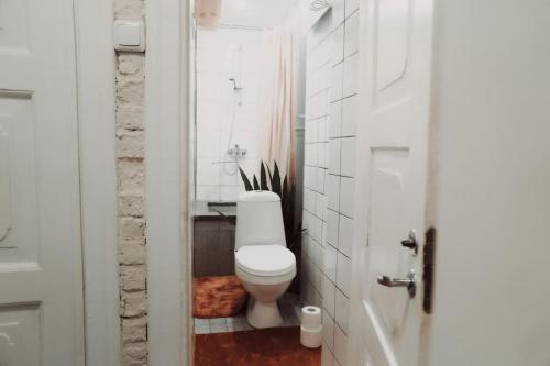 a white bathroom with a toilet and a sink at Cozy apartment in Tallinn Old Town, great location in Tallinn