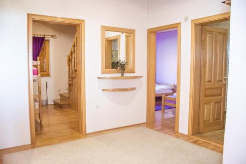 a room with a hallway with two doors and a sink at Holiday Home Green in Rakovica
