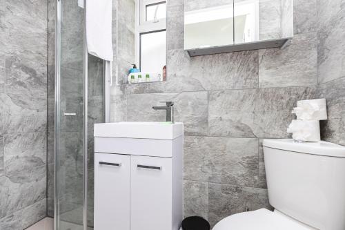 a bathroom with a white toilet and a shower at Stylish studio flat with private patio and free on-street parking in Bournemouth
