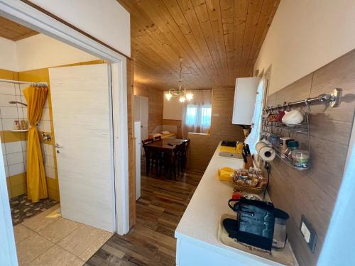 a kitchen with a counter and a dining room at Agriturismo Le Essenze - Terrazza sulla Romagna in Cesena