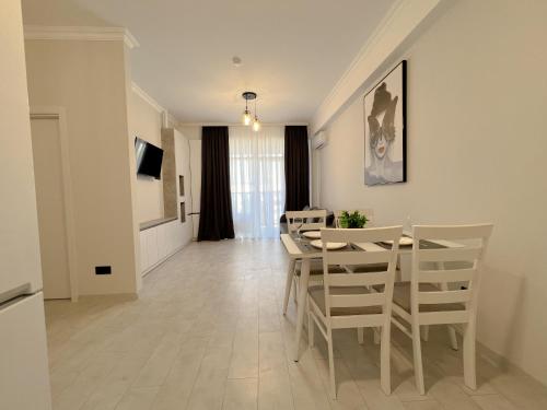 a dining room and living room with a table and chairs at OASIS, Charming 1BD apartment with living room in Chişinău
