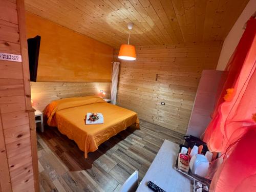 a bedroom with a bed in a wooden room at Agriturismo Le Essenze - Terrazza sulla Romagna in Cesena