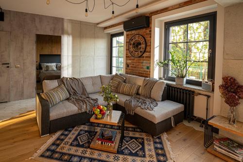 a living room with a couch and a table at Industrial Apartment "I loft Opole" in Opole