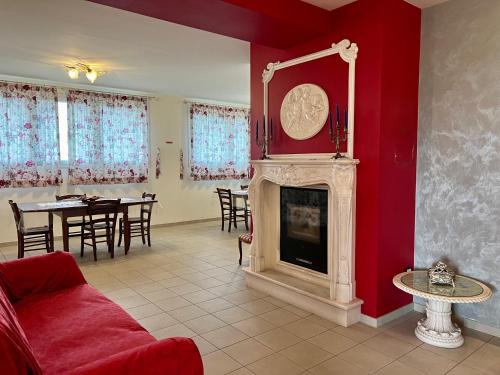 a living room with a fireplace and a dining room at Agriturismo Le Essenze - Terrazza sulla Romagna in Cesena
