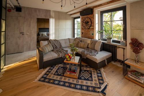 a living room with a couch and a table at Industrial Apartment "I loft Opole" in Opole