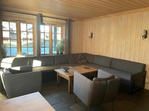 a living room with a couch and a table at Tinden in Hemsedal