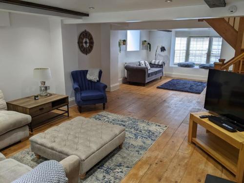 a living room with a couch and a tv at Beautiful Georgian townhouse in central Colchester in Colchester