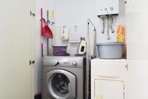 a laundry room with a washer and a washer at Perola, a Home in Madeira in Funchal