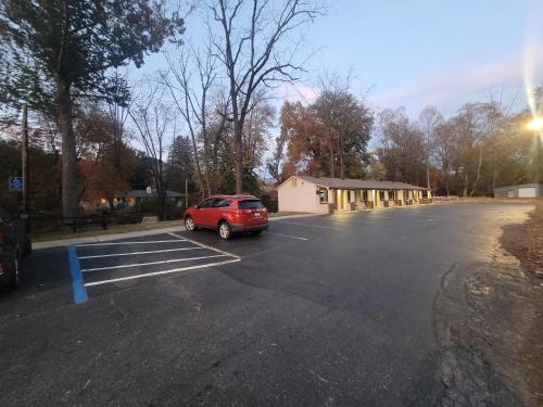 a red car parked in a parking lot at Economy Inn Sylva in Sylva