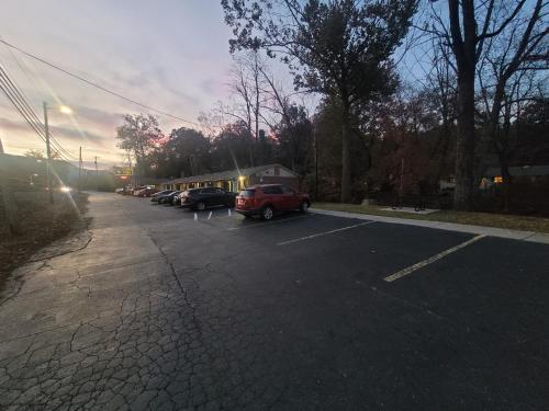 a parking lot with cars parked next to a building at Economy Inn Sylva in Sylva