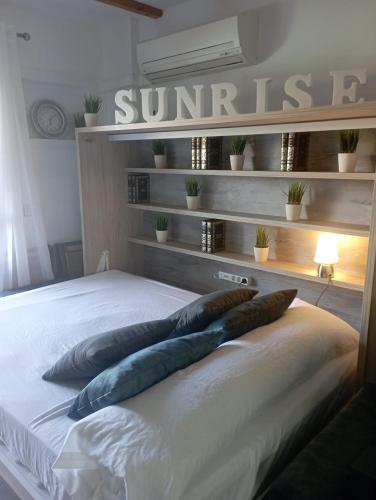 a bedroom with a bed with pillows on it at SUNRISE Vera-naturista in Vera