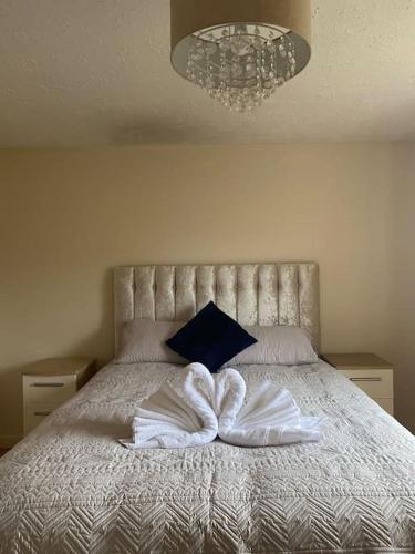a bedroom with a bed with two pillows on it at 3 bedroom home-inverkeithing in Fife