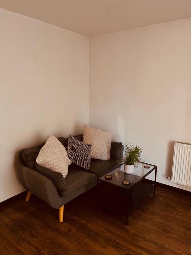 a living room with a couch and a table at 'Woodbury' at stayBOOM in Lancaster