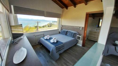 a bedroom with a bed with two teddy bears on it at Las Victorias Suites Bariloche in San Carlos de Bariloche
