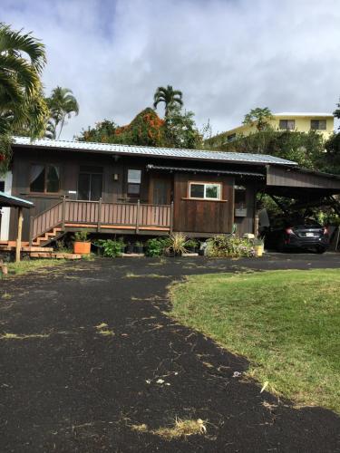 a house with a car parked in front of it at Holualoa bungalows in Kailua-Kona