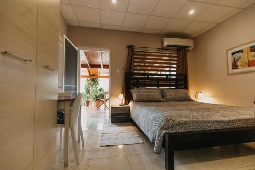a bedroom with a bed with a wooden headboard at Bubali Studio in Palm-Eagle Beach