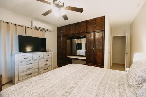 a bedroom with a bed and a flat screen tv at Bubali Studio in Palm-Eagle Beach