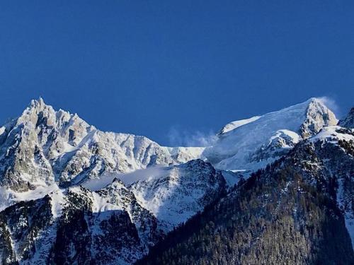 a snow covered mountain range with snow on it at Chalet Amour blanc Chamonix Les Houches in Les Houches