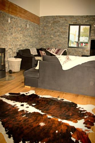 a living room with a couch and a rug at Chalet Amour blanc Chamonix Les Houches in Les Houches