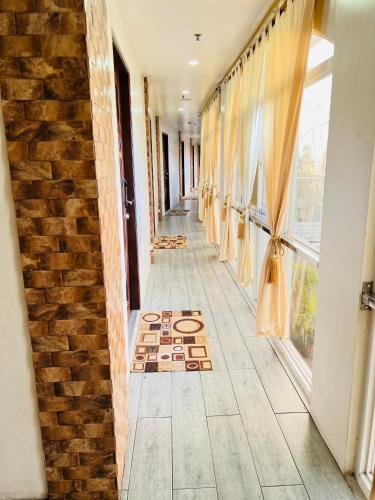 a hallway with a brick wall and a window at III Felix Villas in Naga