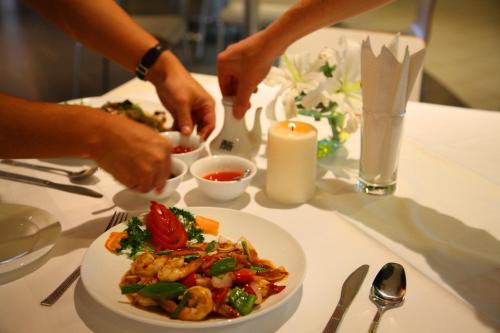a table with a plate of food on a table at Yaya Hotel & Apartments in Nairobi