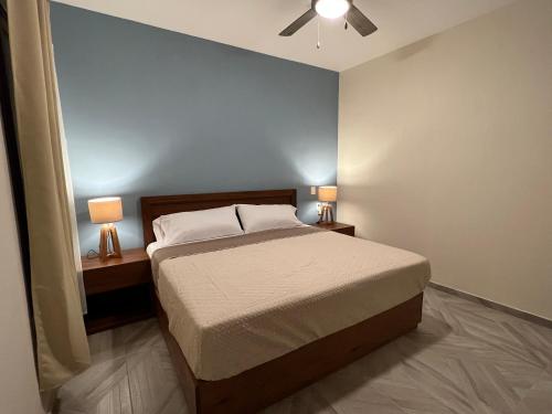 a bedroom with a bed and two lamps on tables at Casona 1530 in Tequila