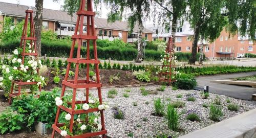 a garden with two red ladders in a garden with flowers at Bålsta Studio Houses in Bålsta
