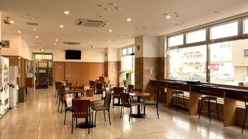 a restaurant with tables and chairs and a bar at Toyoko Inn Hitachi Ekimae in Hitachi
