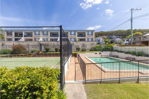 an image of a tennis court with a fence at The Dunes15 fabulous unit with pool tennis court and across the road to the beach in Fingal Bay
