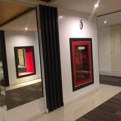 two pieces of art on display in a room at The Beach by Glitter House in Kata Beach