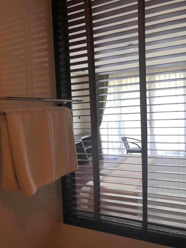 a bathroom with a window with towels and a balcony at The Beach by Glitter House in Kata Beach