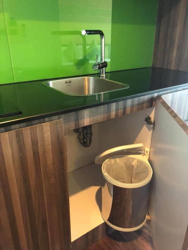a bathroom with a sink and a toilet under a counter at The Beach by Glitter House in Kata Beach